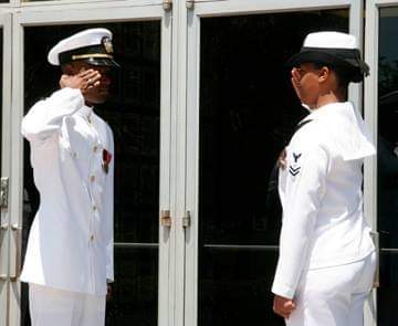 Tenisha Dotstry, owner of Fair Winds Candle Company, giving first salute to her husband, newly commissioned Naval Officer Thomas Dotstry in 2006.